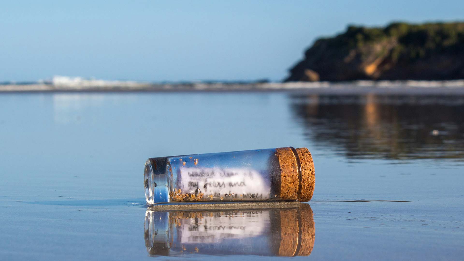A MESSAGE in a bottle, floating in water.