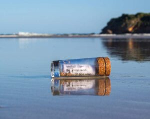 A message in a bottle, floating in water.